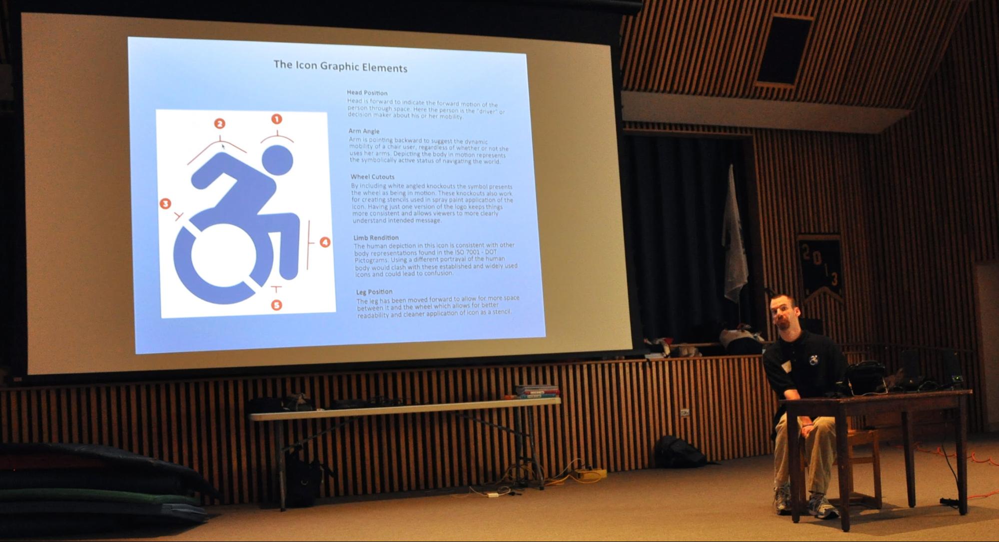 Most gratifying to us is how the project belongs to others, like our self-advocate partner Brendon Hildreth, shown here speaking at an event with a slide of the icon behind him.